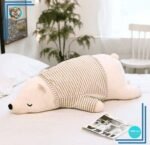 Peluche ours blanc habillé qui dort