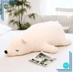 Peluche ours blanc qui dort